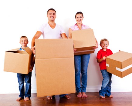Movers handling furniture and boxes during an urgent relocation